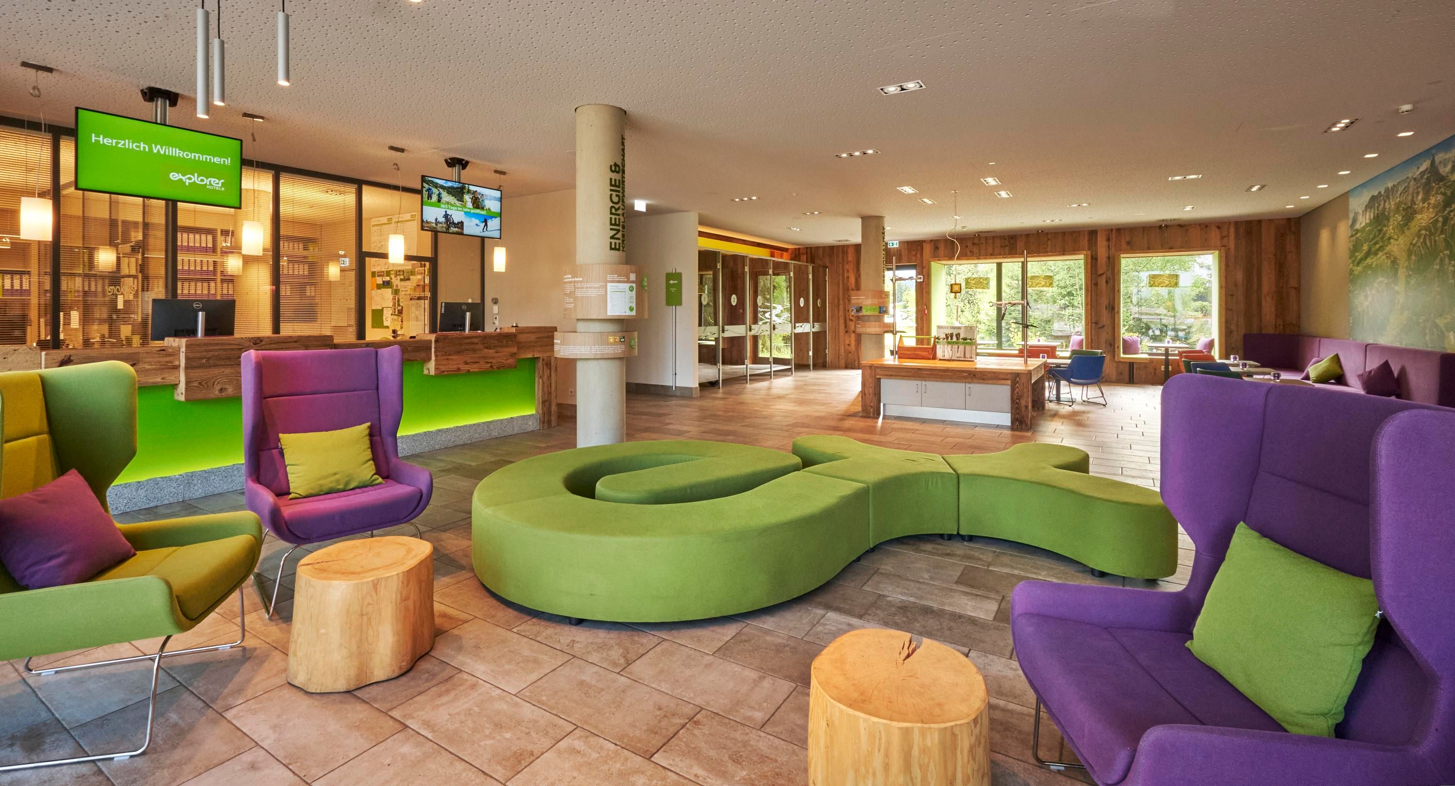A modern foyer with colorful seating and an inviting reception area. The decor is cozy and promotes a relaxed atmosphere.
