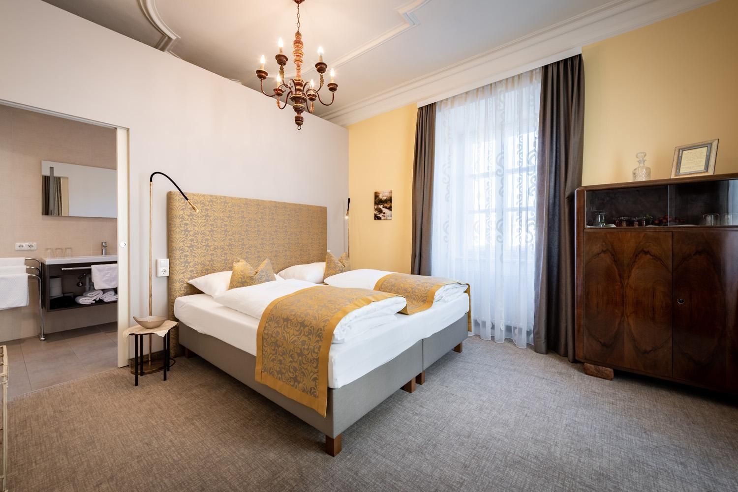 A modern hotel room with two beds, stylishly furnished.
Large windows let in plenty of light and create an inviting atmosphere.