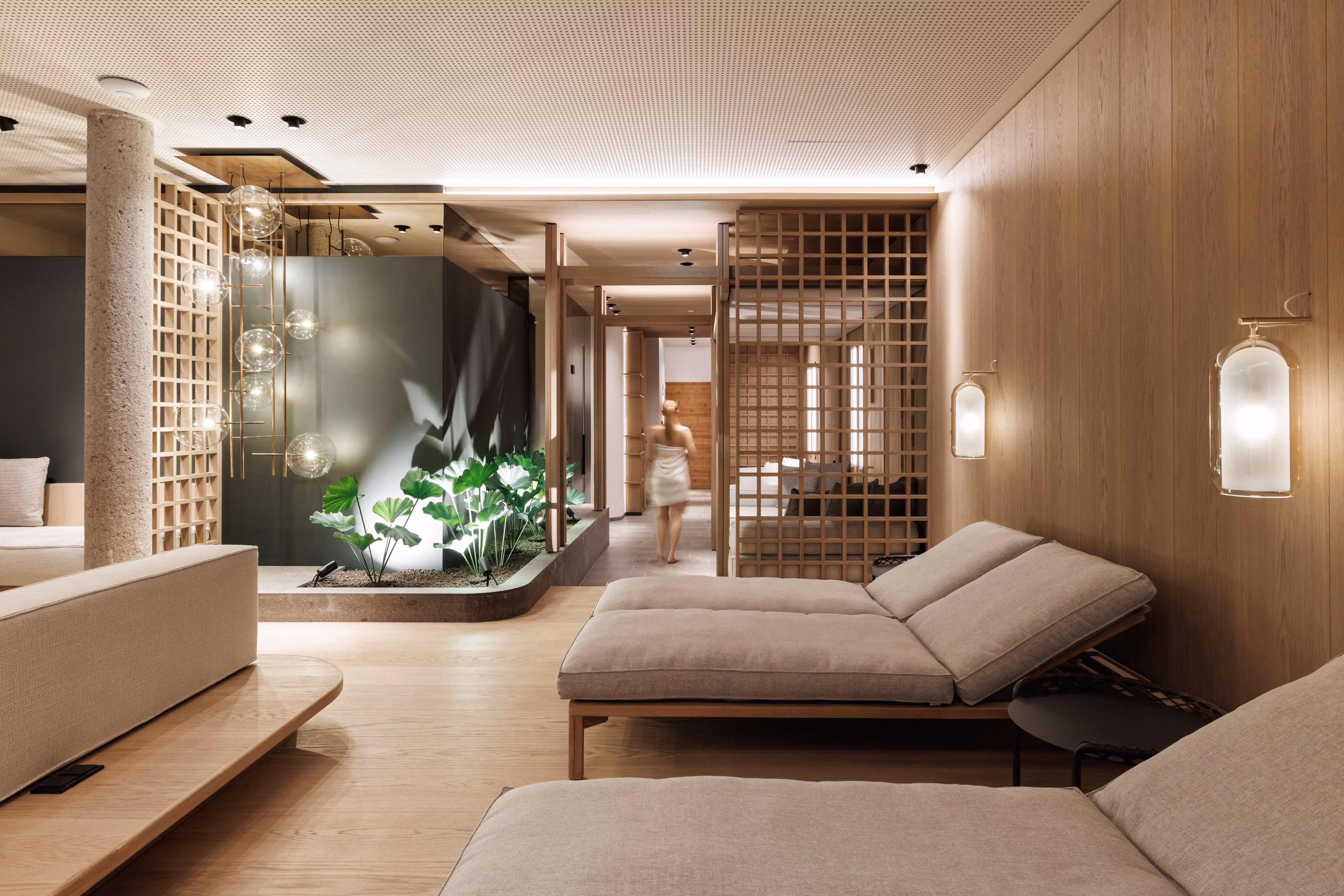 An elegant wellness area with modern loungers and warm wooden tones.
Plants and soft lighting create a relaxing atmosphere.